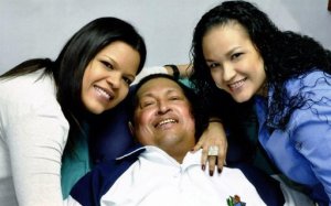 Un Hugo Chávez sonriente, algo hinchado, acostado en una cama, rodeado de sus hijas en esta foto divulgada el viernes por el gobierno venezolano.