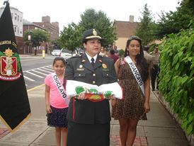 Una representante de la Policía Nacional del Perú traslada la bandera peruana para su izamiento en la Alcaldía de Kearny.
